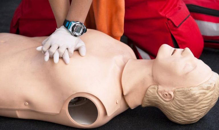 Student practicing CPR on a training dummy during EFR course at Seawave Diving Phuket