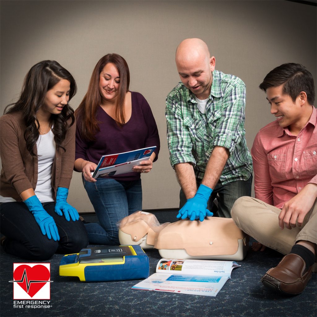 EFR instructor teaching CPR on a training mannequin