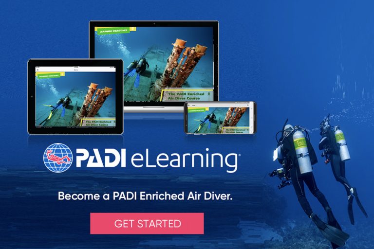 Student completing PADI Enriched Air Nitrox eLearning on a tablet with scuba gear nearby"