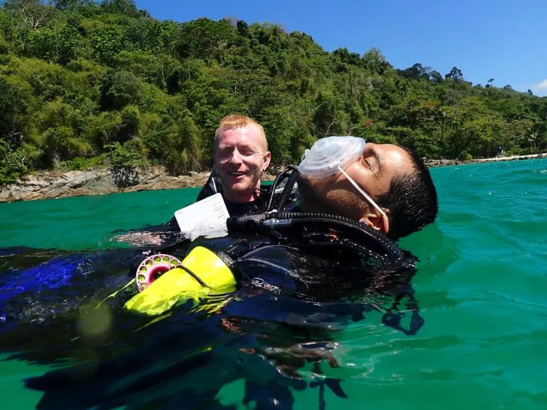 PADI Rescue Diver candidate performing a tired diver tow during open water training