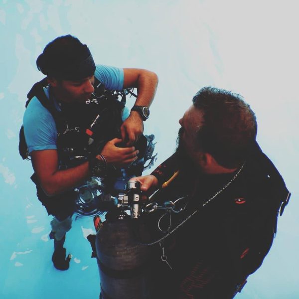 "Sidemount diver switching regulators to manage gas supply during dive"