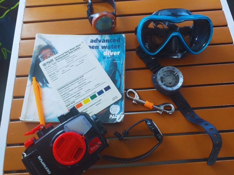 PADI student practicing underwater navigation with a compass