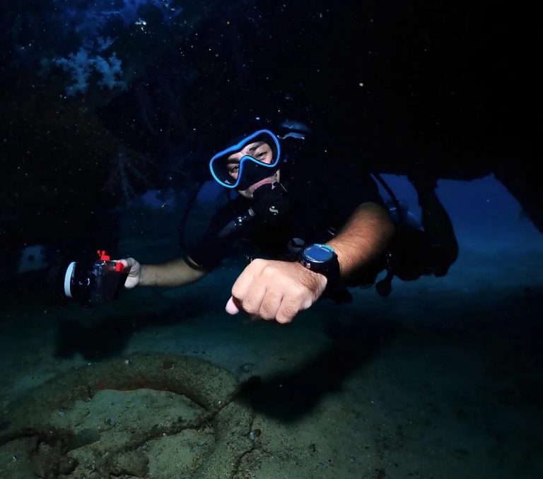 "PADI Deep Diver Specialty student exploring a deep reef wall at 35 meters