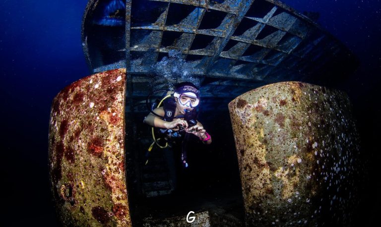 PADI Advanced Open Water diver exploring a sunken wreck during adventure dive