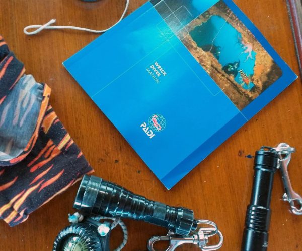 Diver exploring the hull of the King Cruiser wreck in Phuket