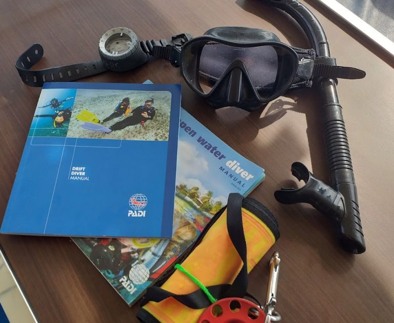 PADI Drift Diver student using DSMB during specialty training dive in Thailand