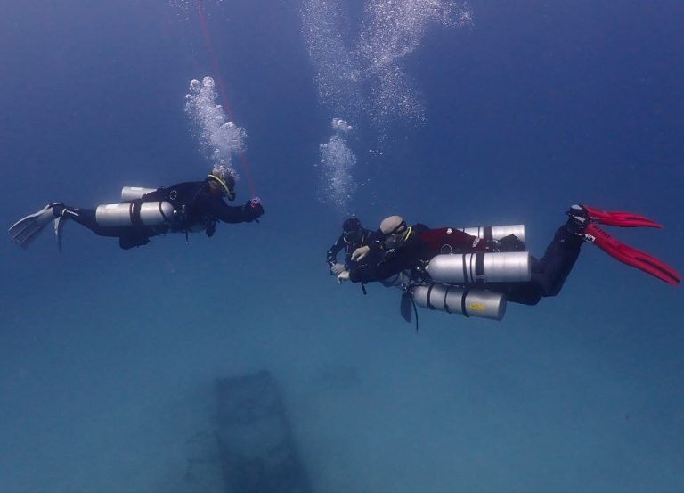 Tec 40 diver performing a decompression stop with stage tank in open water near Phuket