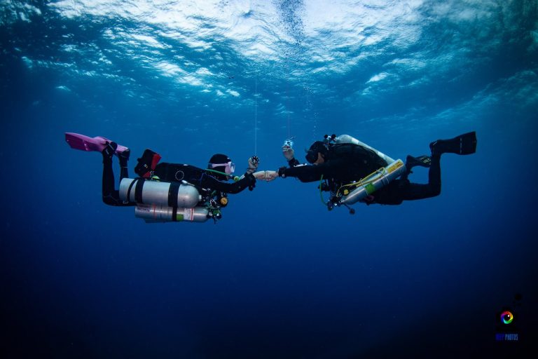 Diver hovering at depth with stage tanks